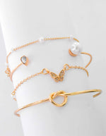 Butterfly charm bracelet paired with dainty gold bar detail