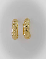 Bold twisted gold earrings with high-polish shine