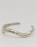 Close-up of bangle’s curved design and silver sheen