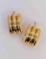 Gold conch earrings styled with minimalist outfit