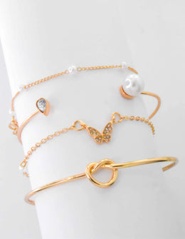 Butterfly charm bracelet paired with dainty gold bar detail