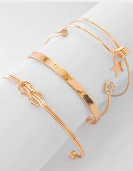 Gold permanent bracelet stack with LOVE engraved centrepiece