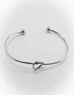 Dainty charm bracelets for women styled with gold cuffs