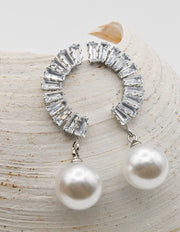 crystal_pearl_arc_ear_wings pair styled on seashell background with pearls