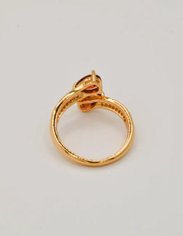 back view of indian rings golden flame teardrop ring with polished gold band and sparkling stone details montreal jewellery