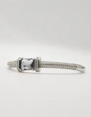“Statement silver bracelet with red crystal centre, sleek loom band, and Canadian jewellery craftsmanship.”