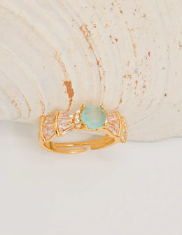 sea_mist_adjustable_ring_back_shell_view – premier jewelry gold adjustable ring with aqua gemstone on seashell background