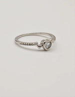 Close‑up view of the Silver Glow Heart Eternity Ring showcasing its polished silver band and brilliant heart centre stone; a Montreal minimalist jewellery favourite and clean girl jewellery trend for 2025