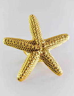 Gold starfish ring close-up on white background